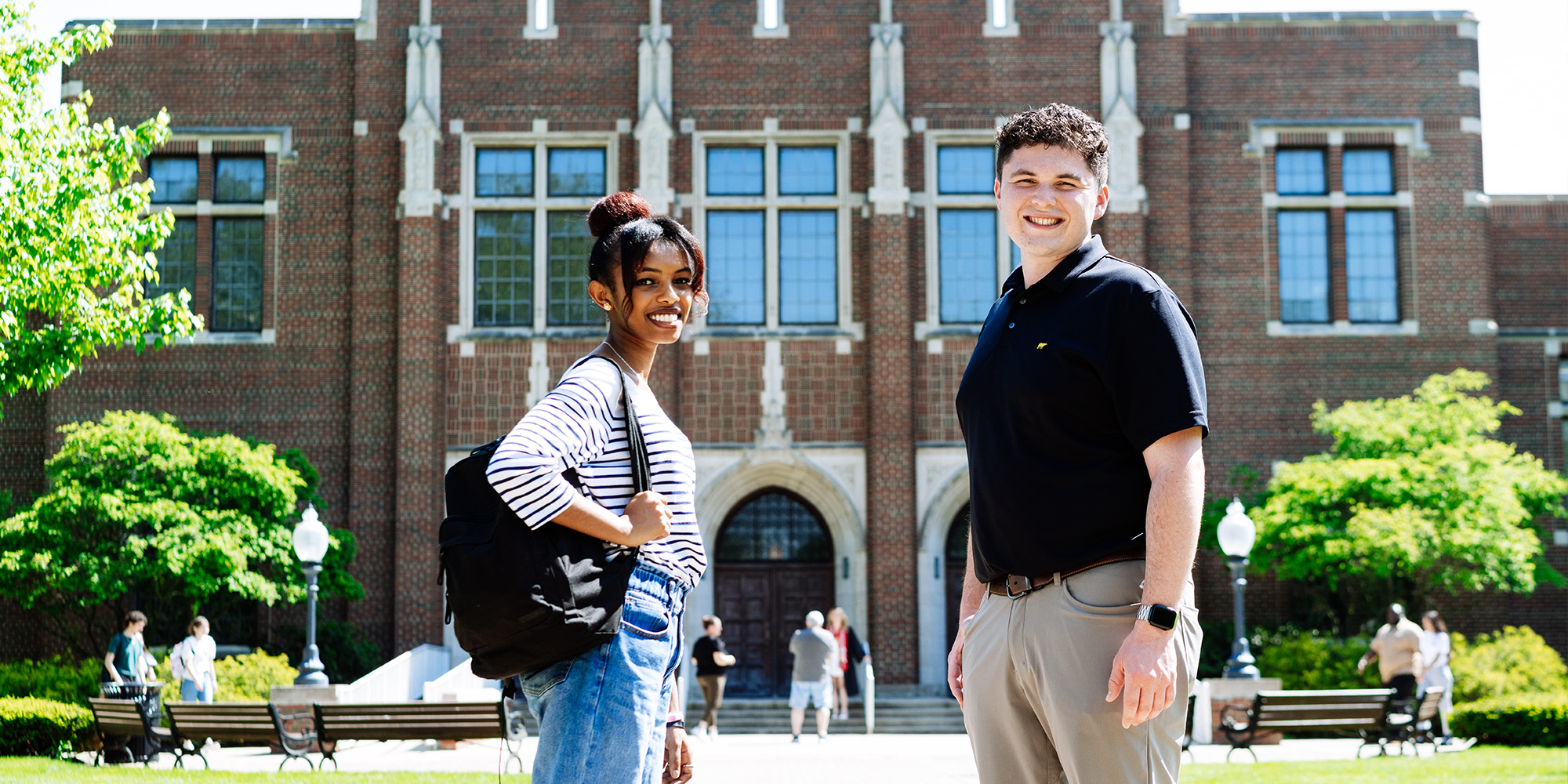 Male And Female Standing In Front Of Mees